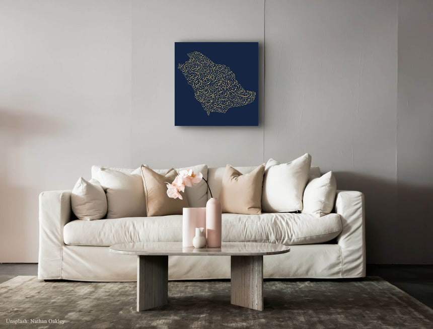 Carved wood artwork of the Saudi Arabia map, drawn in Diwani calligraphy using the names of its cities, in a living room setting