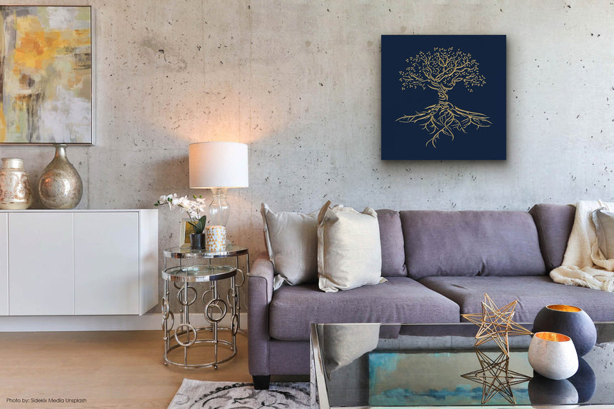 Wooden artwork of an olive tree with the Arabic phrase “The land is ours, and to it we return.” in a living room.