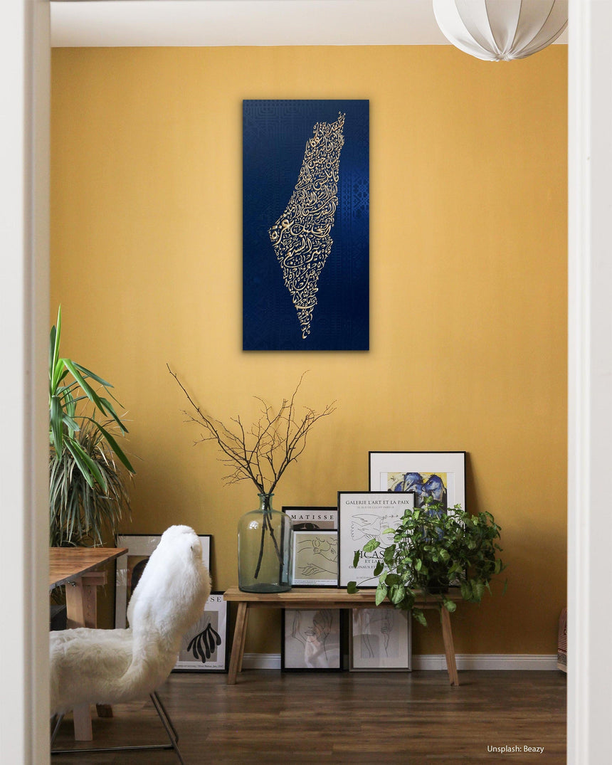 Palestine map in Diwani calligraphy using the names of its cities, with Palestinian tatreez–inspired embroidery in a living room.