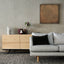 a living room with a couch and a sideboard