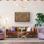 a living room filled with furniture and a painting on the wall