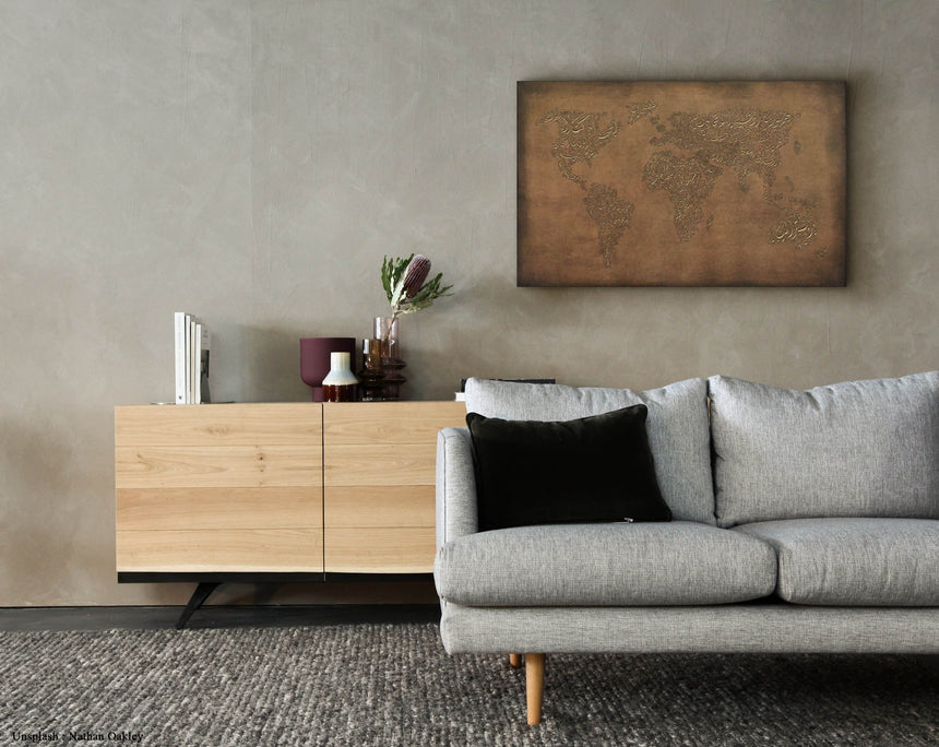 a living room with a gray couch and a wooden cabinet