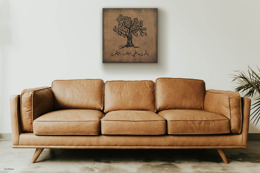 Wooden artwork of an olive tree with the quote “We will remain as long as thyme and olives remain.”  in a living room