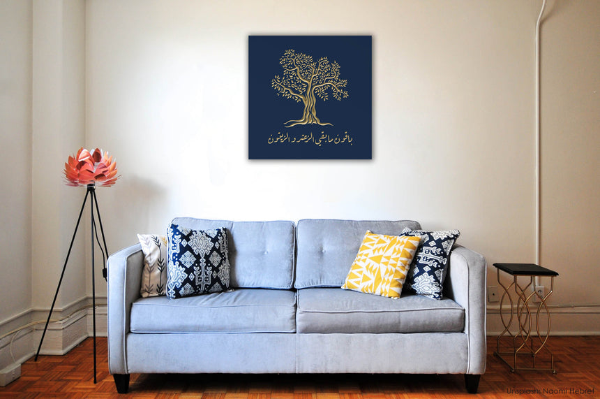 Wooden artwork of an olive tree with the quote “We will remain as long as thyme and olives remain.”  in a living room